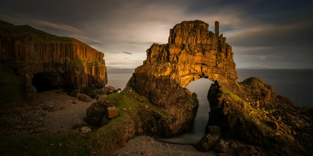 Carsaig Arches on the Ross of Mull, with golden light on the coastal rock formations.